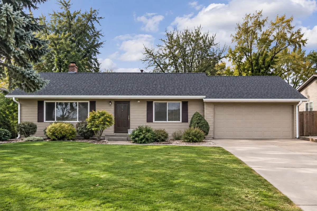 Ranch home with a new impact-resistant shingle roof after replacement