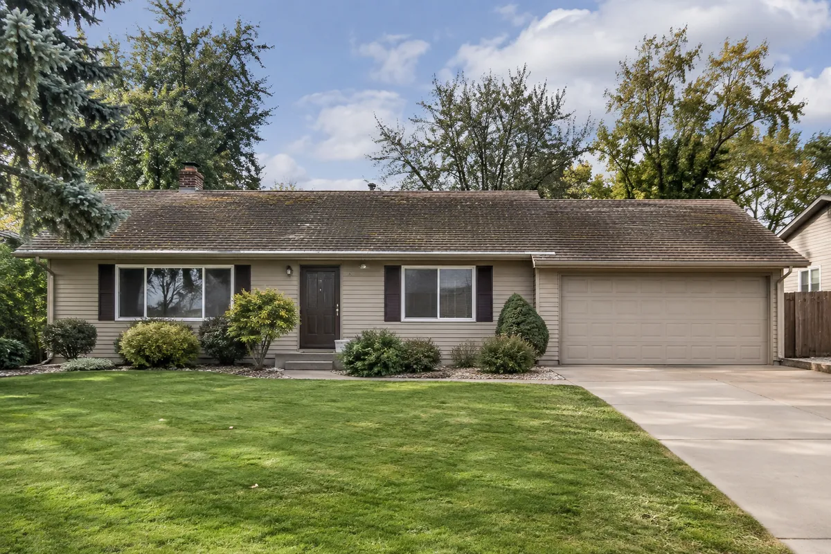 Worn, curling shingle roof on a ranch home before replacement
