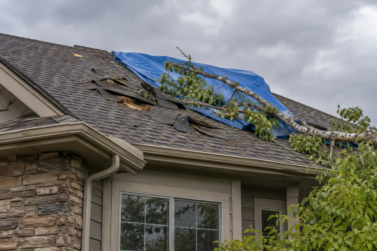 Storm clouds and hail falling over suburban Denver rooftops