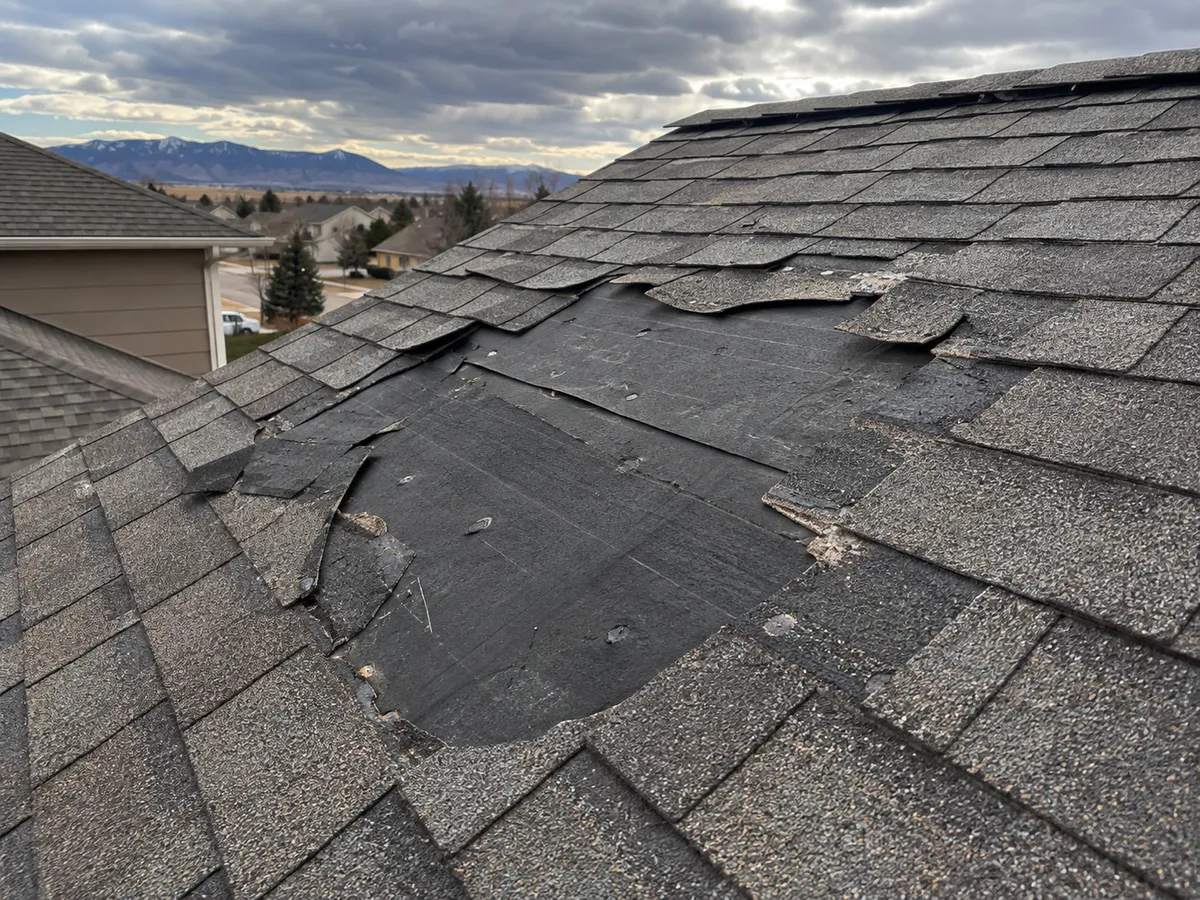 Roof slope with exposed underlayment where shingles blew off in a windstorm